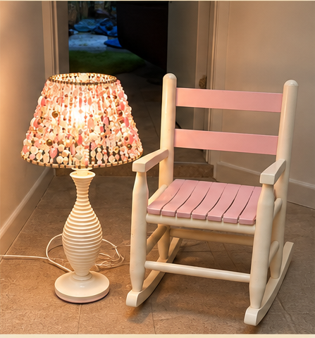 Finished pink pearl and crystal Beaded Light glowing beside the full pink and cream rocking chair